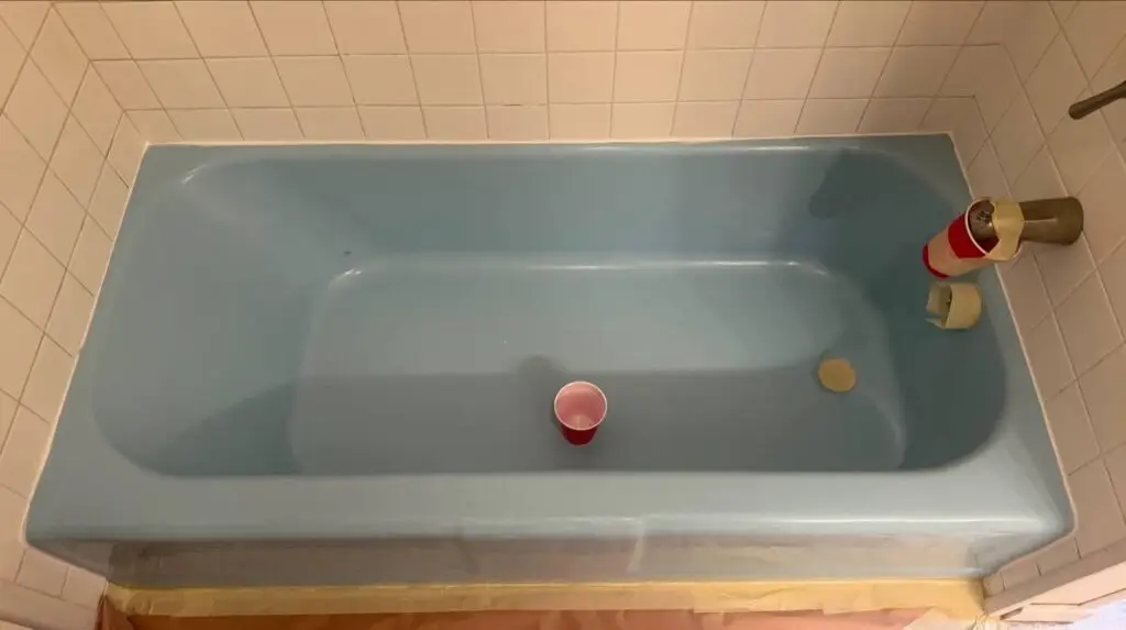 Blue bathtub after removal of the old white coating, before refinishing in Downers Grove, IL.